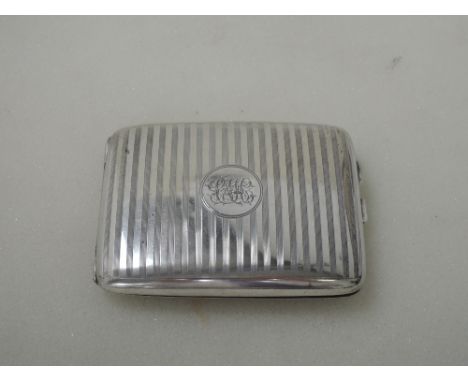 A silver cigarette case having engine turned striped decoration and monogram to cartouche, Birmingham 1919, Henry Williamson,