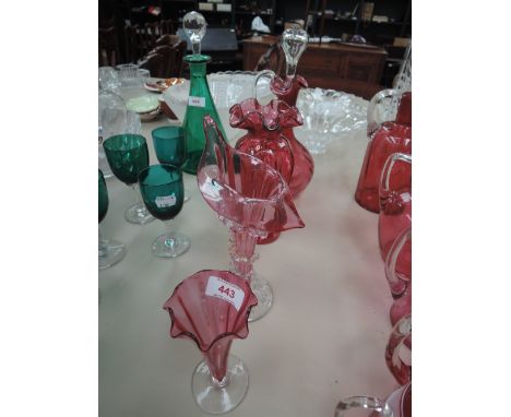 A selection of cranberry glass vases and a decanter