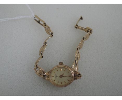 A ladies 9ct gold wrist watch by Rotary having a baton dial to oval face on decorative 9ct gold strap