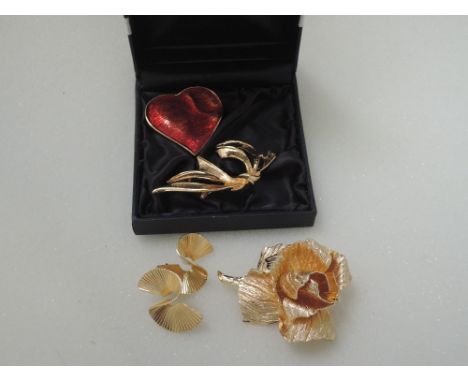 A small selection of costume jewellery including Trifari earrings, YSL enamelled heart pendant/brooch, Christian Dior rose br