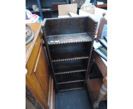 A 1920's oak bookshelf having bobbin trim