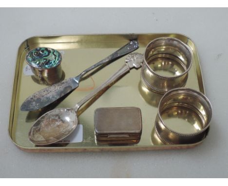 Two HM silver napkin rings having engine turned decoration, an HM silver commemorative teaspoon, HM silver butter knife and t