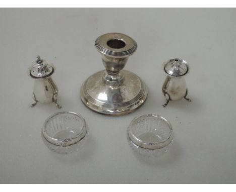 Five pieces of HM silver including two glass dressing table pots having silver collars, two pepperettes and a small candle st