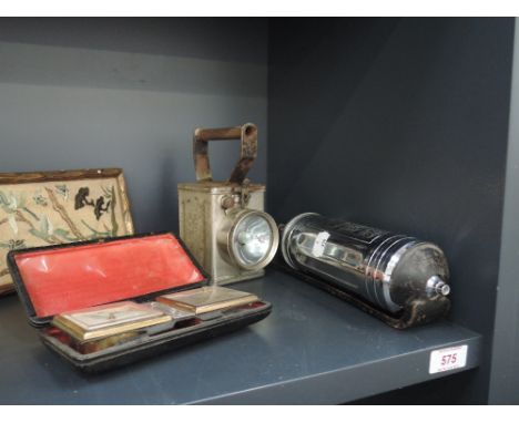 An early 20th century chrome collectors item fire extinguisher, a portable lamp and a travel clock
