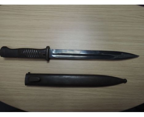 A German World War II bayonet with scabbard, serial number 7290N