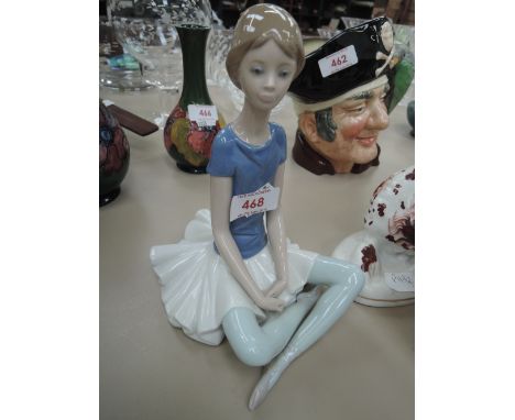 A Lladro figure modelled as seated ballerinna