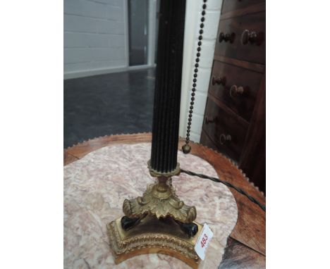 An early 20th century table lamp having fluted column on animalistic trefoil base, stamped MMM Ernest, 1200 20