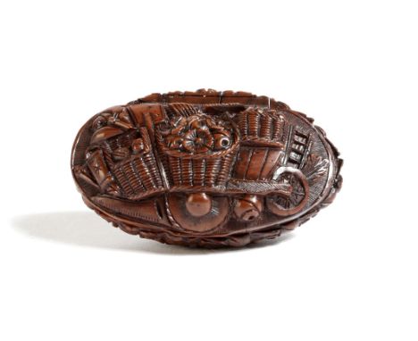 A 19th century French carved coquilla nut snuff box in the form of a basket, the hinged lid carved with a wheelbarrow filled 