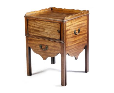 A George III mahogany tray-top bedside commode, with a shaped three-quarter gallery, above a hinged door and a converted pull