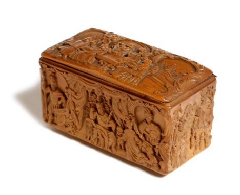 A mid-18th century Rococo boxwood snuff box, carved in relief, the hinged lid with musicians and a lady playing a piano, with