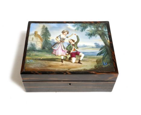 A Victorian coromandel sewing box, the hinged lid inset with a porcelain plaque painted with a couple dancing in a river land