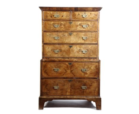 A walnut chest on chest, of two short and five long graduated, feather banded drawers, on bracket feet, 18th century, but top