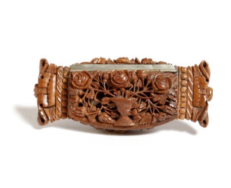 An early 19th century French carved coquilla nut snuff box, the hinged lid with an urn issuing roses, with crown ends, the ba