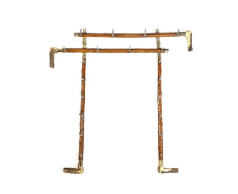 A late Victorian carved ash and antler wall hanging stick rack, in the form of four walking canes, with brass ferrules, appli