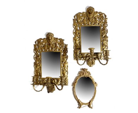 A pair of late 19th century gilt brass girandoles, each with a bevelled rectangular plate, within a scrolling leaf frame, wit