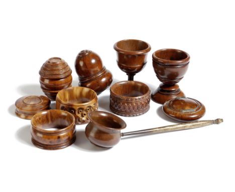 A collection of coquilla nut items, comprising: three napkin rings, two egg cups, a toddy ladle, two nutmeg graters and two d