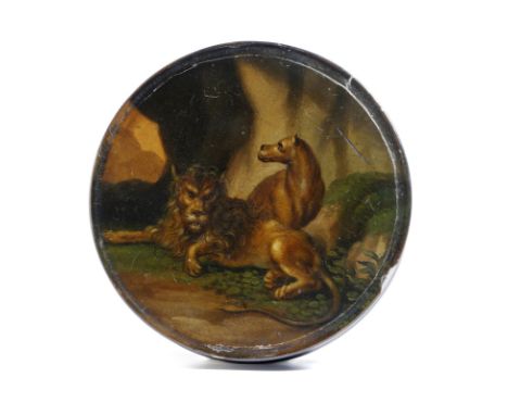 A 19th century German lacquered papier-mâché snuff box, of circular form, the lid painted with a lion and a lioness in a cave
