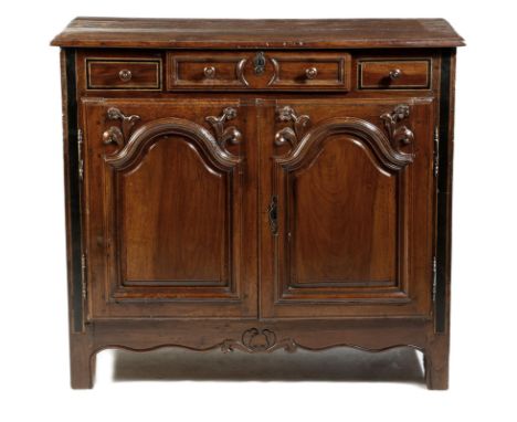 An 18th century French provincial walnut buffet, with a single panel frieze drawer, above a pair of arched doors carved with 