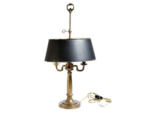 A brass bouillote lamp in early 19th century style, with an adjustable shade above three lights, with scroll arms and a turne