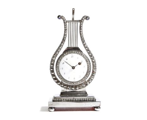 An early 19th century French steel lyre shape timepiece, the brass movement with engraved and pierced decoration, with a whit