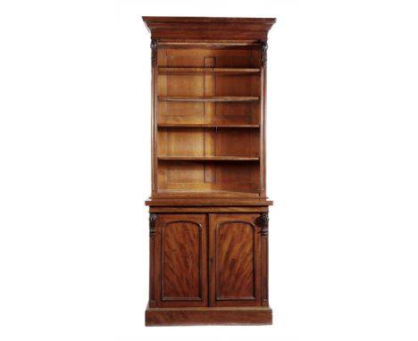A near pair of Victorian mahogany bookcase cabinets, each with a detachable cornice, above four adjustable shelves, with appl