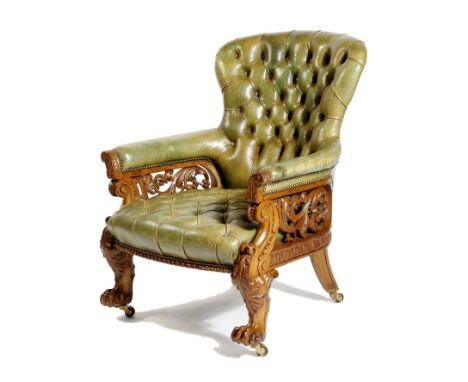 A William IV oak library armchair, button upholstered with green leather, the frame carved with scrolling acanthus leaves and