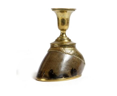 A late Victorian brass mounted hoof candlestick by Rowland Ward, with an urn shape sconce, the base stamped 'ROWLAND WARD & C