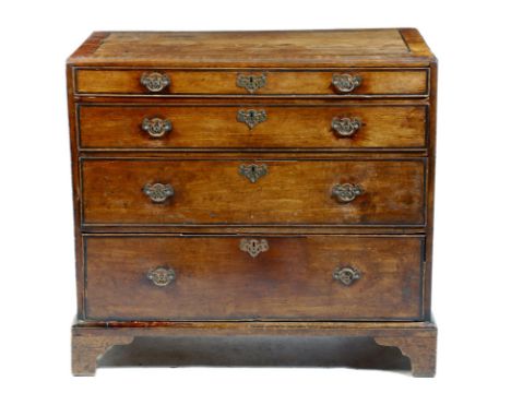 A George II walnut chest, with ebonised banding, the crossbanded top with a caddy moulded edge, above four long graduated dra