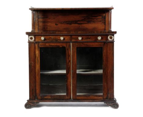 λ A Regency rosewood side cabinet, the raised back with a lancet arched brass gallery, the base with a pair of frieze drawers