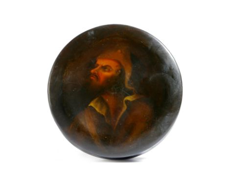 A 19th century lacquered papier-mâché snuff box, of circular dished form, the lid painted with a bust of a peasant, 9.6cm dia