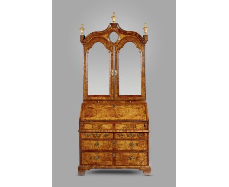 A George I walnut and burr walnut bureau bookcase, cross and feather banded, the double domed top with a moulded cornice with