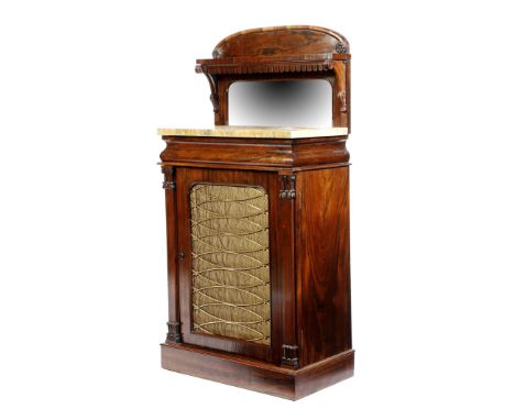 λ A Regency rosewood side cabinet, the raised top carved with flowerheads and scrolls, with a shelf above a mirror and a Sien