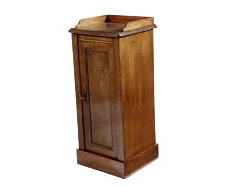 A Victorian mahogany bedside cupboard attributed to Holland & Sons, with a three-quarter gallery, above a panelled door enclo