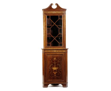 A late Victorian mahogany and marquetry standing corner cabinet, with an astragal glazed door enclosing two shelves, the base