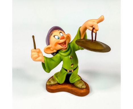 Ceramic figure in matte finish modeled as dopey from Snow White and The Seven Dwarfs playing the cymbal. Walt Disney Collecti