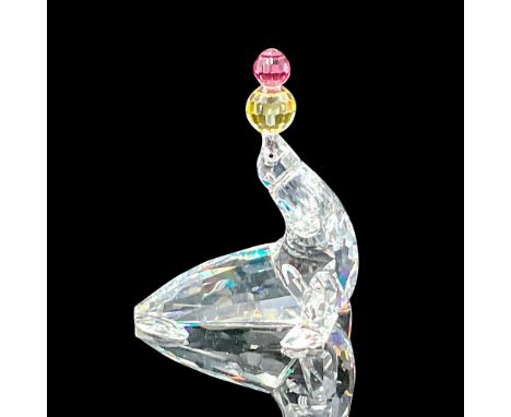 Part of the 'Cheerful Times' group. A clear crystal seal with black eyes, balancing rose-pink and jonquil-yellow crystal ball