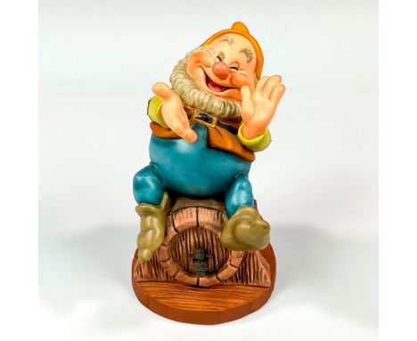 Ceramic in matte finish depicting happy seated on a barrel smiling. Walt Disney Collection backstamp. This item has its origi