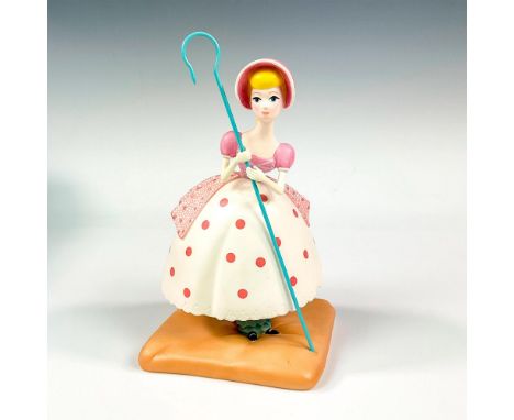 Ceramic in matte finish modeled as Bo Peep from Toy Story carrying her long cane. Walt Disney Collection backstamp. This item