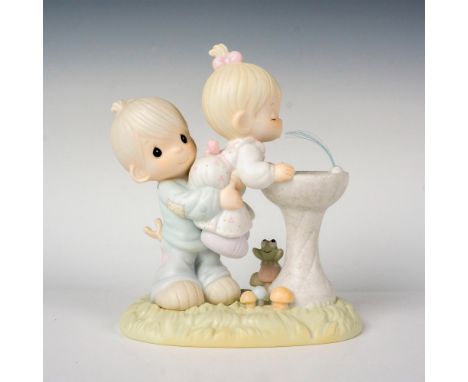Features a little boy helping a little blonde girl get a sip of water. Precious Moments backstamp. This item has its original