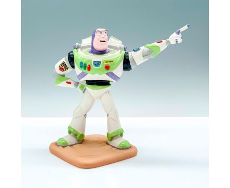 A porcelain figure of Buzz Lightyear from Disney's Toy Story in an action pose. Walt Disney Classics Collection backstamp. Th