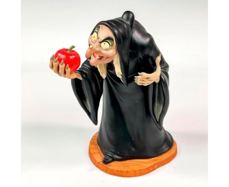 Ceramic figure with matte finish. Depicts witch from Snow White and the Seven Dwarfs holding the poisonous apple. Walt Disney