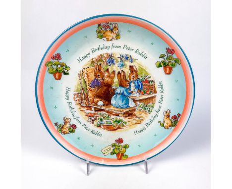 Collectors plate with an illustration of Peter Rabbit and his family and illustrations on surface with the year 2001.This ite