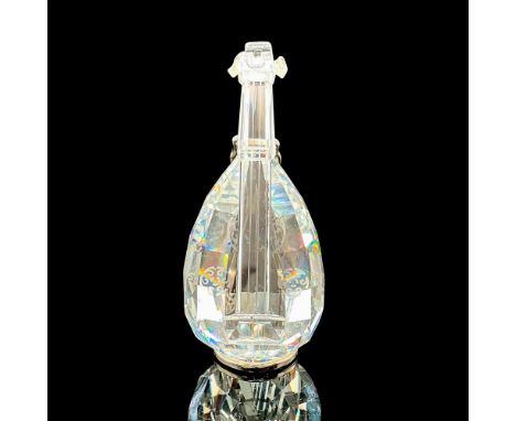 Part of the Crystal Melodies' collection. Depicts a clear string instrument. Includes a rhodium metal stand. Swarovski laser 