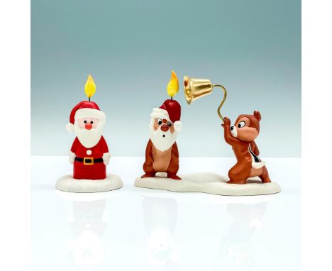 A pair of porcelain figures, one being a Santa shaped candle lit from the head, the other is Chip and Dale imitating the cand
