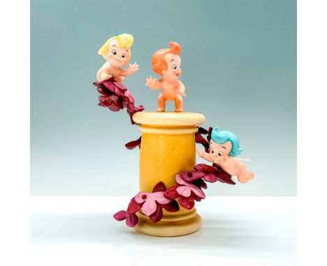 A porcelain figure of the three cherubs from Disney's Fantasia flying around a pillar surrounded by flowers. Walt Disney Clas