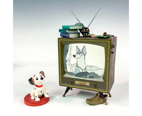 Ceramic in matte finish modeled as Lucky from 101 Dalmatians watching tv. Walt Disney Collection backstamp. Tv measures: 4.5"