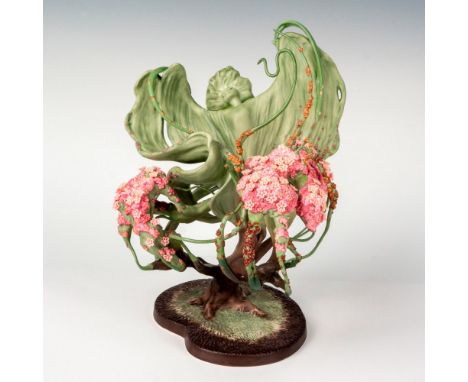 A porcelain figure of the Spring Sprite from Disney's Fantasia coming out of the foliage of a tree. Walt Disney Classics Coll