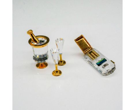 Clear crystal that is gilded on champagne bucket with glasses. Flip telephone with gold toned keypad and green crystal rest. 