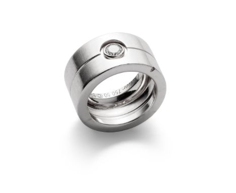 A diamond-set ring, by Cartier The wide 18ct white gold band with engraved central line, collet-set with a brilliant-cut diam