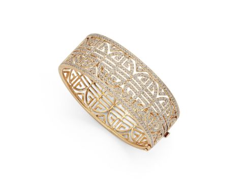 A diamond-set bangle The wide bangle of bi-coloured openwork geometric design, set to the front with brilliant-cut diamonds(I